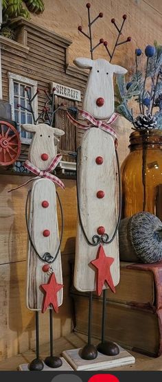 two wooden snowmen standing next to each other