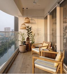 a balcony with chairs and plants on it