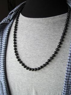 "Men's Beaded Necklace, Onyx, Matte Onyx and Lava. An alternating pattern of black onyx, matte black onyx and lava gemstone beads are used to make this stylish men's necklace. Between each larger bead is a smaller bead which gives the feel of traditional knotting, but the whole thing is strung on 49 strand stainless steel beading wire so it is very sturdy and strong yet still beautifully flexible with a really nice drape. The necklace is finished off with a stainless steel clasp and ring which I Necklace Gift Ideas, Holly Springs Nc, Mens Beaded Necklaces, Necklace Mens, Mens Necklace, Causal Outfits, Black Bead Necklace, Beading Wire, Men's Necklace