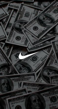 a pile of money with the nike logo on it