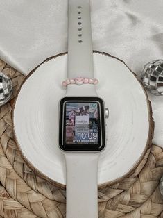 an apple watch sitting on top of a wooden slice