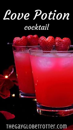 two glasses filled with red liquid and strawberries on the rim, sitting next to each other