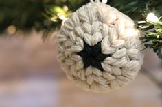 a crocheted ornament hanging from a christmas tree