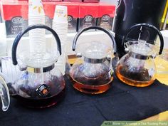 three tea kettles sitting on top of a table