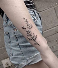 a woman's arm with flowers on it and the words flowers done by kate at chronic ink in toronto on