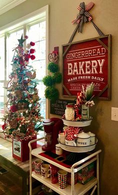 a decorated christmas tree in the corner of a room with an old fashioned bakery sign