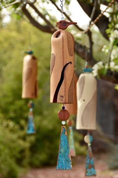 three wooden wind chimes hanging from a tree