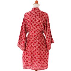 Like nebulae in a ruby red universe, spinning particles are bordered by classic Indonesian frieze. Saktut Raitawati designs this rayon robe featuring the beauty of Balinese batik artistry. The short robe features three-quarter length sleeves, a self-tie belt, and two side seam pockets. The robe can alternately be worn as a long jacket with Asian chic. 100% rayon Hand wash or machine wash on gentle cycle One size fits most Handcrafted batik art--colors and pattern placement will vary Handmade in Red Bohemian Robe With Kimono Sleeves, Traditional Red Kimono For Festival, Traditional Red Long Sleeve Robe, Traditional Red Robe With Long Sleeves, Traditional Long Red Robe, Festive Red Kimono With Kimono Sleeves, Red Universe, Red Nebula, Paw Print Jewelry