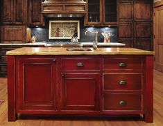 a large kitchen with wooden cabinets and an island in the middle is decorated with wood flooring