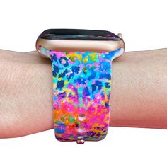 the colorful apple watch band is on someone's arm and it looks like they are covered in paint