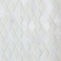 a white marble mosaic tile pattern with diamond shaped tiles in the center and diagonals on each side