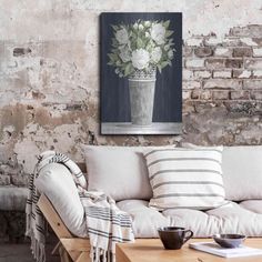 a living room filled with furniture and a painting on the wall above it's coffee table