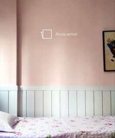 a small bed in a room with pink walls