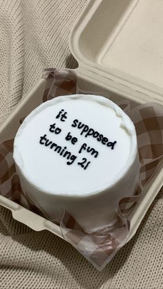 a cake in a plastic container that says it's supposed to be fun turning 21