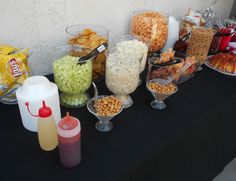 a table topped with lots of different types of food and drinks on it's sides