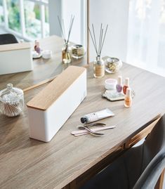 a wooden table topped with lots of beauty products on top of it's surface