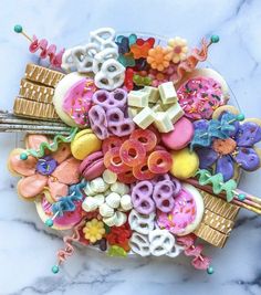 a plate full of assorted donuts and candy on top of a marble table