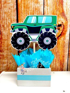 a monster truck cupcake topper in a box