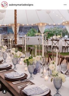 the table is set with candles, plates and napkins for dinner guests to enjoy