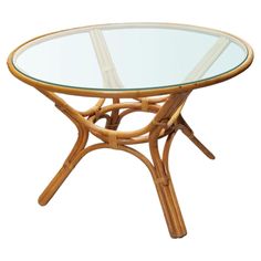 a table with a glass top and wooden legs