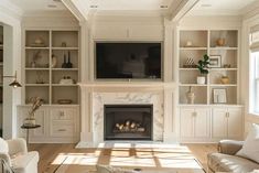 a living room filled with furniture and a flat screen tv mounted on the wall above a fire place