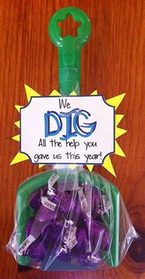 purple candies in a plastic bag with a green keychain that says we dig all the help you give us this year