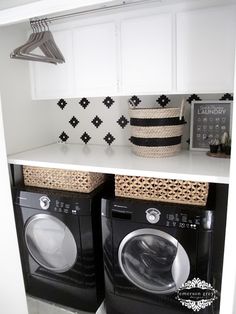 a washer and dryer are sitting on the shelves in this small laundry room