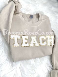 "This cozy chenille patch TEACH sweatshirt is the perfect crewneck sweatshirt for your favorite teacher! The sweatshirt is the Gildan brand unisex sizing. They run true to size so =if you'd like a baggy sweatshirt we recommend sizing up. It is crewneck, long sleeve and has elastic at the sleeve cuff and bottom waistband. We offer 3 sweatshirt colors (white, grey and sand) and 2 patch colors (light pink and cream white). Colors may appear slightly different in person versus on the computer screen Baggy Sweatshirt, Teacher Attire, Cute Teacher Outfits, Teacher Wardrobe, Custom Teacher Gifts, Chenille Patch, Teaching Outfits, Teacher Sweatshirt, Dance Mom