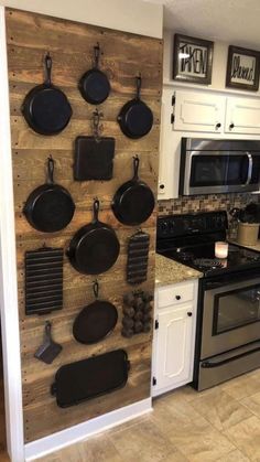 a kitchen with pots and pans mounted to the wall