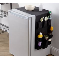 a small refrigerator with its door open next to a table