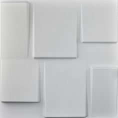 white square and rectangle tiles are arranged on the wall