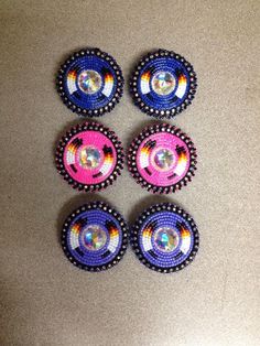 four small beaded buttons sitting on top of a table