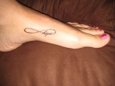 a woman's foot with a tattoo saying hope