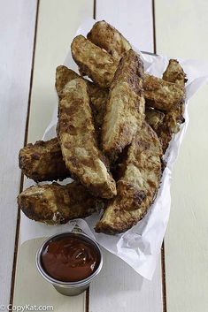 fried chicken sticks in a basket with dipping sauce