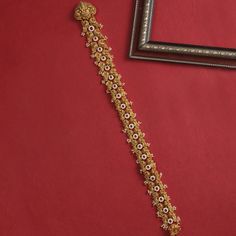 Description: Elevate your bridal style with the exquisite beauty of our Temple Nakshi hair brooch. This intricately crafted brooch is inspired by the ancient artistry of temple jewelry. Adorned with intricate motifs and delicate detailing, it captures the essence of traditional Indian heritage. Details & Specifications: Materials used: Brass Alloy with Antique Gold Plating Weight - 270.35 gm, Length - 60 cm Make it custom Want to make it a custom hair accessories? Sure! Reach out to us at suppor Temple Jewelry Tikka With Intricate Design, Traditional Gold Hair Accessories For Wedding, Traditional Gold Wedding Hair Accessories, Temple Jewelry Tikka For Ceremonial Occasions, Ceremonial Temple Jewelry Tikka, Elegant Meenakari Tikka For Puja, Ceremonial 22k Gold Tikka With Intricate Design, Elegant Zari Work Jewelry For Puja, 22k Gold Wedding Tikka With Intricate Design