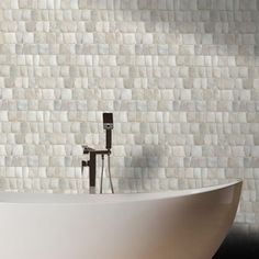 a white bath tub sitting next to a wall