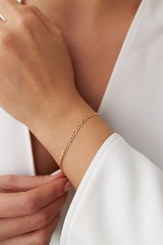 Our new simple and dainty Figaro chain bracelets, as always made in 14k solid gold. You can wear this bracelet with a free mind without worrying about water, perfume, or conditioner contact since real gold never tarnishes.★ Features of the Bracelet (this listing is for a single bracelet only)• Gold Kt: 14K Solid Gold (all pieces are stamped for authenticity)• Available Gold Color: Yellow Gold• Chain Width: 2.5 mm Single Bracelet, Water Perfume, Solid Gold Bracelet, About Water, Free Mind, Chain Bracelets, Figaro Chains, Figaro Chain, Yellow Gold Chain