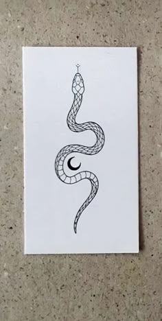 a sticker with a snake on it sitting next to a white paper sheet that says, don't tread