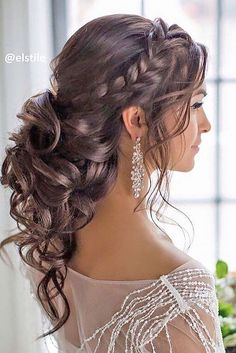 the side view of a woman's hair with braids and flowers in it