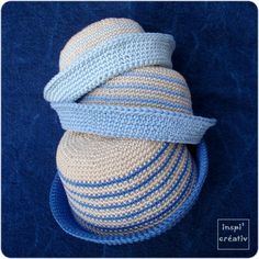 a crocheted hat sitting on top of a blue bowl