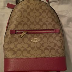 Brand New Coach Backpack. I Got It As A Christmas Gift And Gave No Use For It. There Are Zero Blemishes. It Unfortunately Wasn’t Gifted With The Duster Bag But I Have Photos Of The Authenticity Label In The Photos. The Price Is Just Based On What I Found Online. I Am Open To Reasonable Offers! Please Let Me Know If You Have Any Questions. I Will Ship Same Day If Before Noon Pst Or Next Day. Coach Bags | Nwot Coach Kenley Brown H2179-C5679 Signature Coated Canvas Backpack | Color: Red/Tan | Size: Red Leather Standard Backpack, Designer Red Backpack, Red Backpack With Removable Pouch, Chic Red Backpack Bag, Coach Burgundy Bag With Zipper Closure, Red Backpack With Removable Pouch For On-the-go, Red Satchel Backpack For On-the-go, Travel Backpack In Coated Canvas, Coated Canvas Travel Backpack