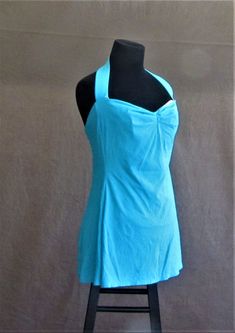 Retro 40s style skirted one-piece bathing suit by Bill Blass in a women's size 14 in turquoise/aqua with pinched front, halter style straps, and skirted bottom. The suit has a sewn-in soft cup bra. The material is 92% Antron Nylon and 8% Lycra Spandex The suit is in excellent vintage condition and appears to have been well taken care of...plenty of stretch in the fabric so the original owner must have followed the care instructions to the letter. No holes, tears, or stains. The suit is a Bill Bl Bathing Suit One Piece, 40s Style, Bathing Suits One Piece, Soft Cup Bra, 40s Fashion, Bill Blass, Cup Bra, Soft Cup, Pin Up Style