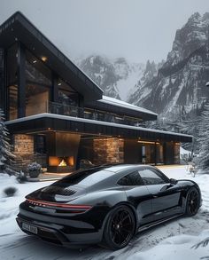 a black sports car parked in front of a large house with snow on the ground