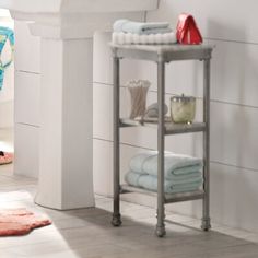 a white sink sitting under a bathroom mirror next to a shelf with towels on it