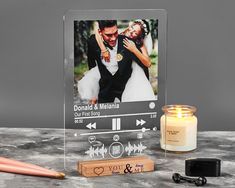 a personalized photo is placed next to a candle and some other items on a table