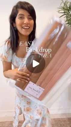 a woman is holding up a package with the words e - asy back drop on it