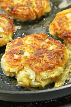 four crab cakes cooking in a skillet on the stove top, ready to be cooked