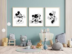 two mickey mouse pictures hanging on the wall in a child's room with toys