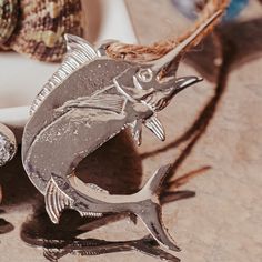 a metal fish sculpture sitting on top of a counter