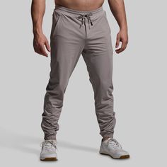 It doesn’t get more lightweight than this. Made from an ultra-breathable fabric, our Performance Jogger boasts distraction-free comfort that’s made for warm days in the gym, on the track, or around town. Added stretch provides maximum range of motion while a side-zipped leg opening allows for even greater mobility. With the ideal balance of comfort, function, and utility, these joggers will quickly become your go-to for summer training days. Sporty Activewear With 4-way Stretch And Breathable Fabric, Breathable 4-way Stretch Activewear For Gym, Functional Activewear With Light Support And Breathable Fabric, Sporty Solid Color Activewear For Running, Solid Go-dry Activewear For Running, Solid Go-dry Running Activewear, Gray 4-way Stretch Sweat-resistant Activewear, Sporty Breathable Nylon Activewear, Breathable Nylon Sporty Activewear